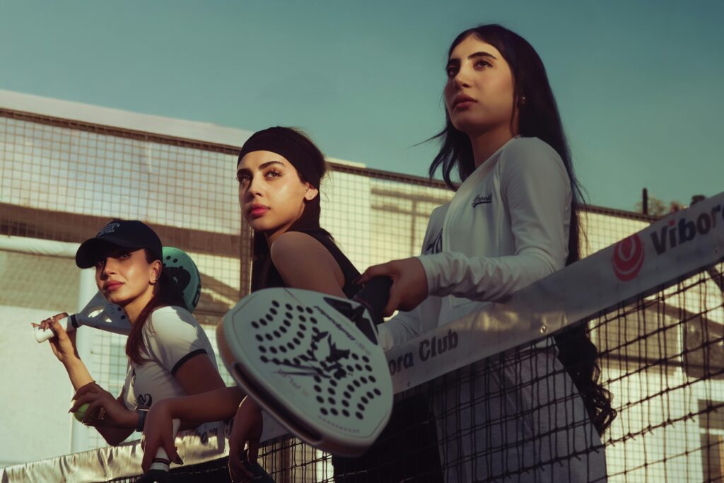 Three women play padel tennis at a court in Baghdad, Iraq.